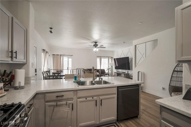 6388 Extreme Shear Ave Unit 103, Henderson, NV 89011 - kitchen featuring stainless steel appliances, open floor plan, a peninsula, ceiling fan, and wood finished floors