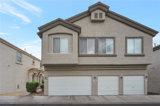 6388 Extreme Shear Ave Unit 103, Henderson, NV 89011 - view of front of house featuring stucco siding and an attached garage