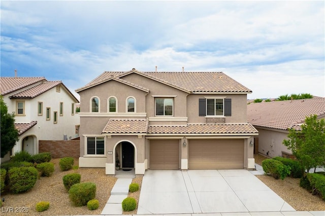 1084 Via Della Costrella, Henderson, NV 89011 - mediterranean / spanish home with stucco siding, an attached garage, concrete driveway, and a tile roof