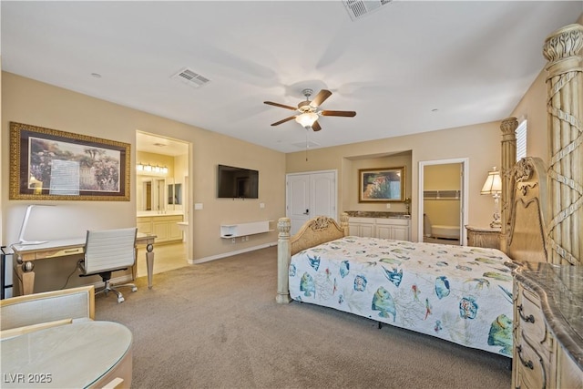 1084 Via Della Costrella, Henderson, NV 89011 - carpeted bedroom with connected bathroom, a desk, and a ceiling fan