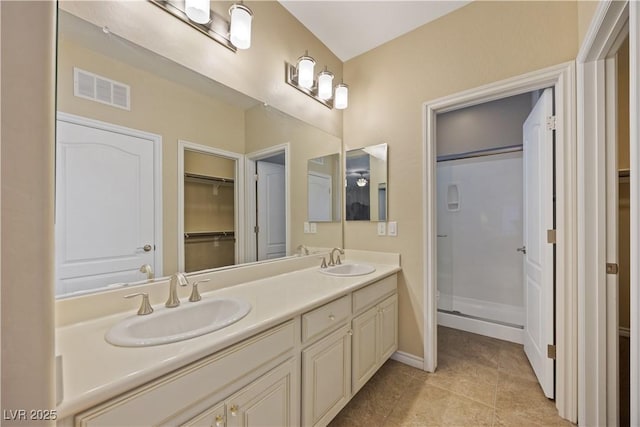 1084 Via Della Costrella, Henderson, NV 89011 - full bath with a spacious closet, double vanity, a shower stall, and tile patterned floors
