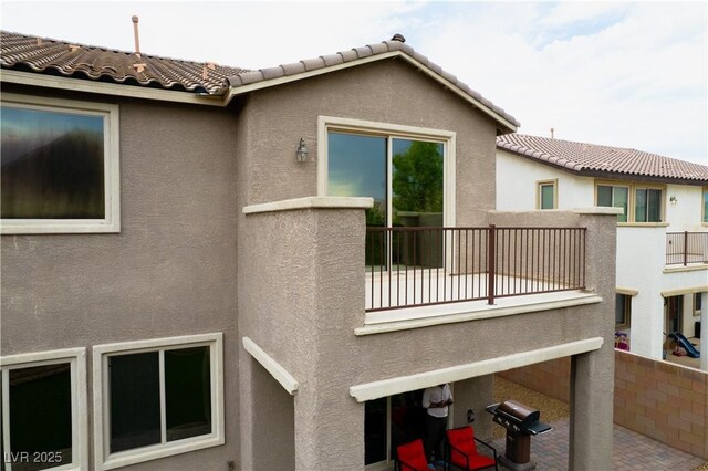 1084 Via Della Costrella, Henderson, NV 89011 - back of house with a balcony, stucco siding, and a tile roof