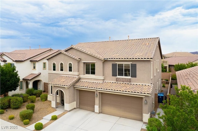 1084 Via Della Costrella, Henderson, NV 89011 - mediterranean / spanish-style home featuring a garage, a tiled roof, stucco siding, and driveway