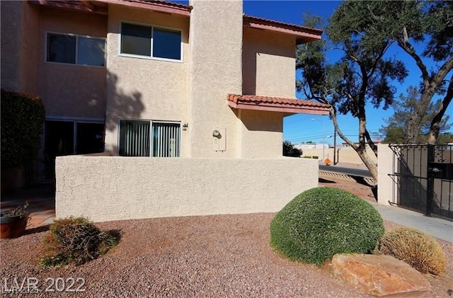 3393 Narod St, Las Vegas, NV 89121 - rear view of house featuring a tile roof and stucco siding
