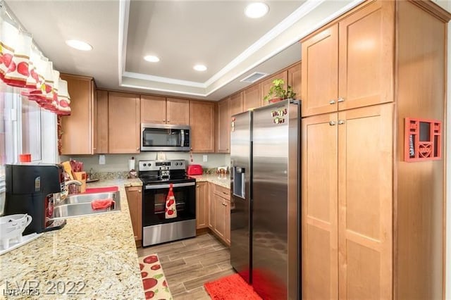 3393 Narod St, Las Vegas, NV 89121 - kitchen with stainless steel appliances, light wood-style floors, a tray ceiling, crown molding, and recessed lighting