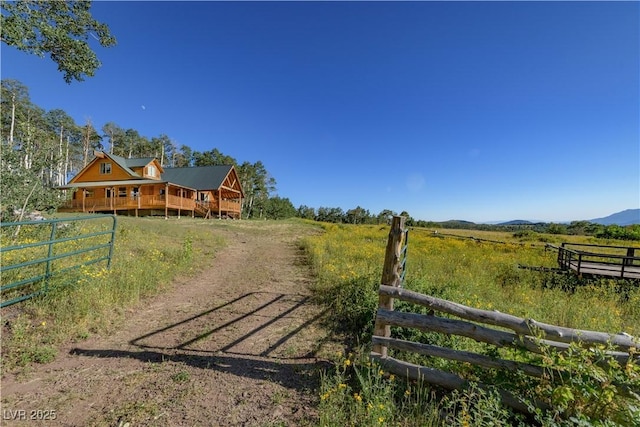 1458 W 6400 S, Cedar City, UT 84720 - view of dirt / gravel driveway featuring a view of countryside, a mountain view, and a gated entry