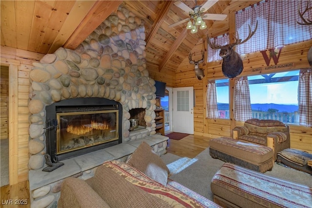 1458 W 6400 S, Cedar City, UT 84720 - living room with a wooden ceiling with exposed beams, a stone fireplace, wood finished floors, ceiling fan, and wood walls