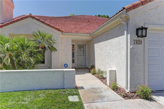 7629 Oyster Cove Dr, Las Vegas, NV 89128 - property entrance featuring a tile roof, stucco siding, and a garage