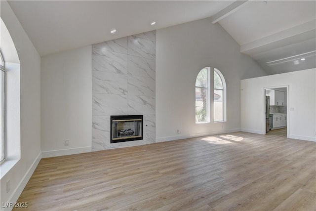 7629 Oyster Cove Dr, Las Vegas, NV 89128 - unfurnished living room featuring a fireplace, beamed ceiling, wood finished floors, recessed lighting, and high vaulted ceiling