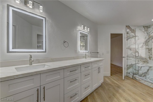 7629 Oyster Cove Dr, Las Vegas, NV 89128 - bathroom featuring wood finished floors, a marble finish shower, and double vanity