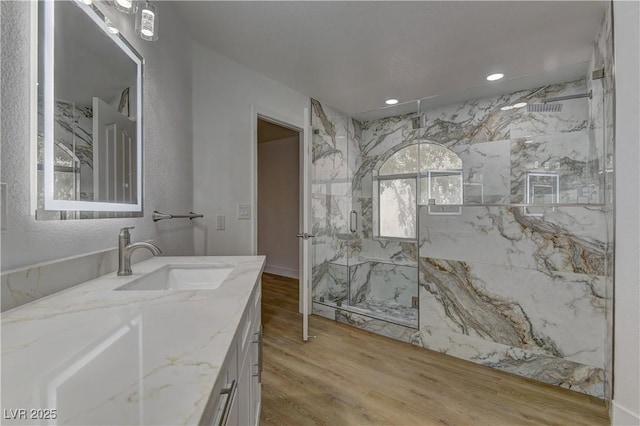 7629 Oyster Cove Dr, Las Vegas, NV 89128 - full bath with a marble finish shower, vanity, wood finished floors, and recessed lighting