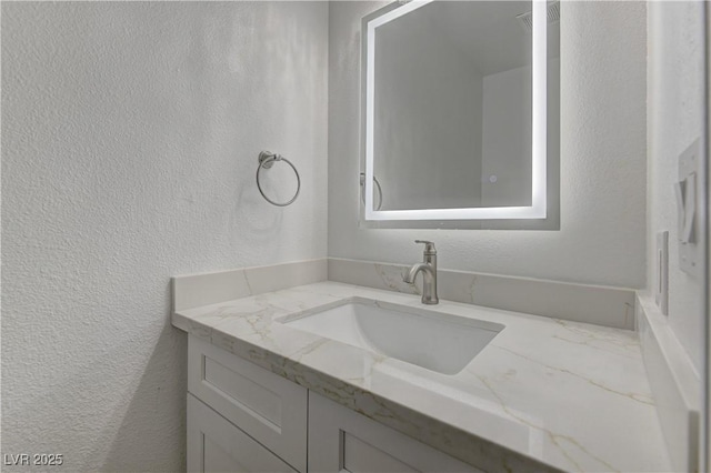 7629 Oyster Cove Dr, Las Vegas, NV 89128 - bathroom featuring vanity and a textured wall