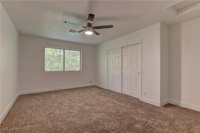 7629 Oyster Cove Dr, Las Vegas, NV 89128 - unfurnished bedroom featuring carpet, a closet, attic access, ceiling fan, and a textured ceiling