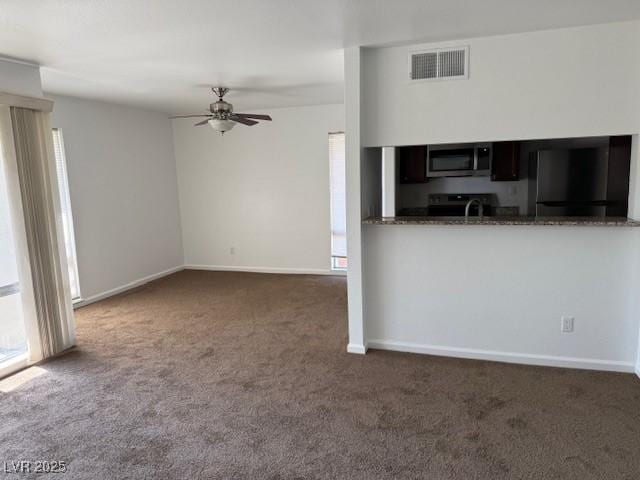 793 Oakmont Ave Unit 202, Las Vegas, NV 89109 - kitchen featuring stainless steel microwave, carpet, refrigerator, and ceiling fan