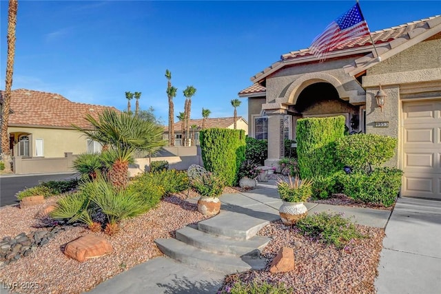 9553 Gainey Ranch Ave, Las Vegas, NV 89147 - view of exterior entry featuring a tile roof and stucco siding