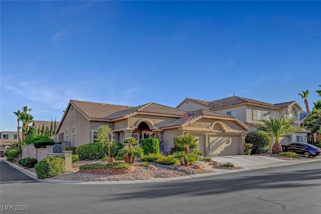 9553 Gainey Ranch Ave, Las Vegas, NV 89147 - mediterranean / spanish-style house featuring an attached garage, stucco siding, a tiled roof, and concrete driveway