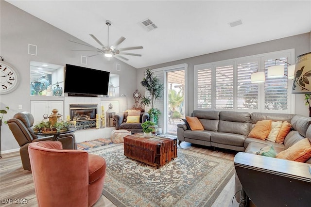 9553 Gainey Ranch Ave, Las Vegas, NV 89147 - living area with light wood finished floors, lofted ceiling, ceiling fan, and a fireplace