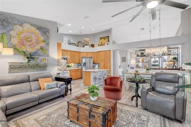 9553 Gainey Ranch Ave, Las Vegas, NV 89147 - living area with a ceiling fan, light wood-style floors, a high ceiling, a chandelier, and recessed lighting