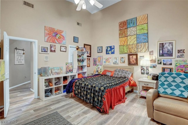 9553 Gainey Ranch Ave, Las Vegas, NV 89147 - bedroom with a towering ceiling, wood finished floors, and a ceiling fan