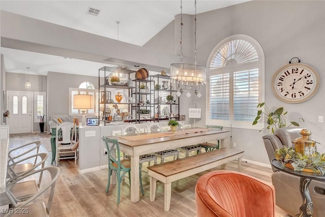 9553 Gainey Ranch Ave, Las Vegas, NV 89147 - dining space with light wood-style floors, healthy amount of natural light, high vaulted ceiling, and a chandelier