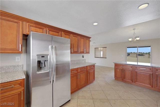 1770 W Charleston Park Ave, Pahrump, NV 89048 - kitchen with stainless steel refrigerator with ice dispenser, brown cabinets, a chandelier, recessed lighting, and light tile patterned flooring