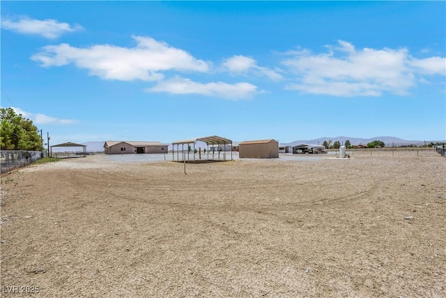 1770 W Charleston Park Ave, Pahrump, NV 89048 - view of yard with a detached carport, dirt driveway, and a mountain view
