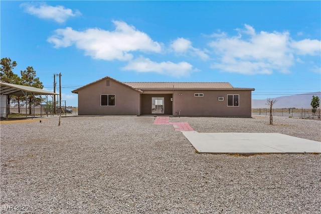 1770 W Charleston Park Ave, Pahrump, NV 89048 - rear view of property featuring stucco siding, a tiled roof, and a patio