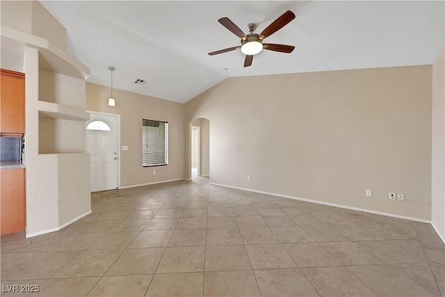 1770 W Charleston Park Ave, Pahrump, NV 89048 - unfurnished living room featuring ceiling fan, lofted ceiling, light tile patterned floors, and arched walkways