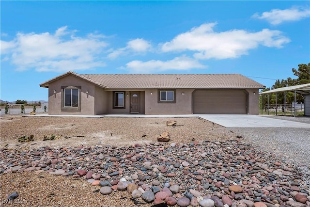 1770 W Charleston Park Ave, Pahrump, NV 89048 - ranch-style house featuring a tile roof, stucco siding, driveway, and an attached garage