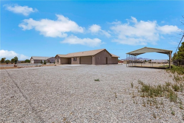 1770 W Charleston Park Ave, Pahrump, NV 89048 - rear view of property featuring gravel driveway, an attached garage, and a gazebo