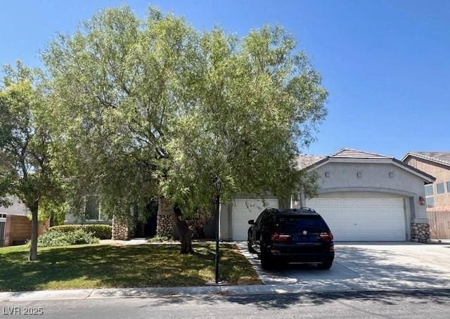 8505 Starstruck Ave, Las Vegas, NV 89143 - view of front facade with concrete driveway, an attached garage, stucco siding, and a front yard