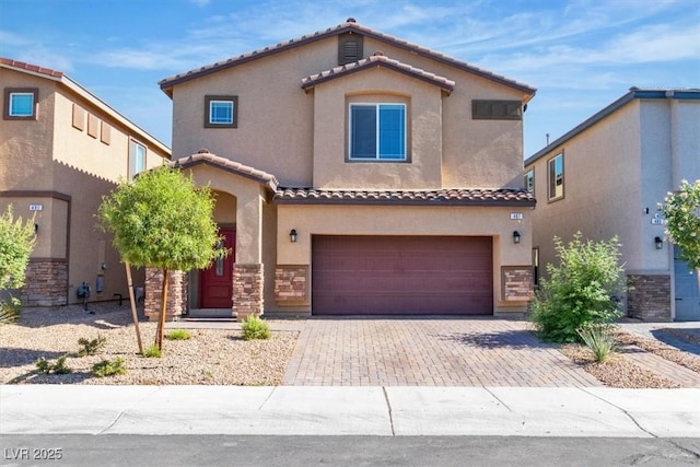 487 Via Renata, Henderson, NV 89044 - mediterranean / spanish house featuring stone siding, stucco siding, a tile roof, an attached garage, and decorative driveway