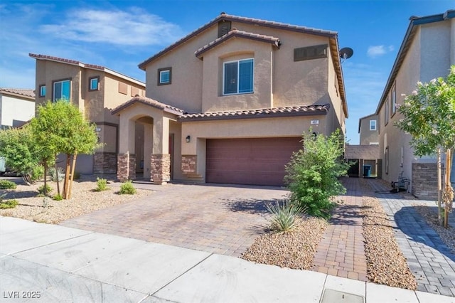 487 Via Renata, Henderson, NV 89044 - mediterranean / spanish house with stucco siding, decorative driveway, an attached garage, and a tiled roof