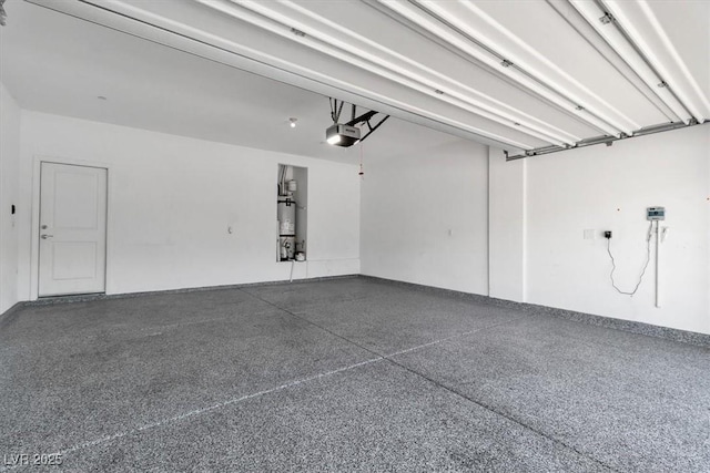 487 Via Renata, Henderson, NV 89044 - garage featuring a garage door opener and strapped water heater