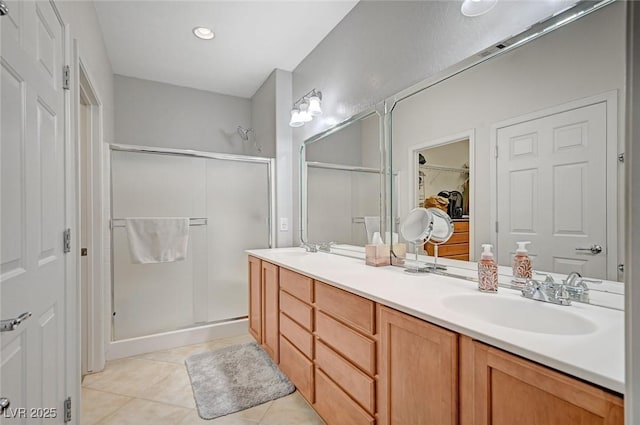 7460 Chaffinch St, North Las Vegas, NV 89084 - full bath featuring a stall shower, double vanity, tile patterned floors, and a spacious closet