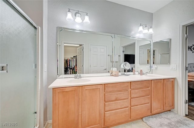 7460 Chaffinch St, North Las Vegas, NV 89084 - bathroom featuring a stall shower, double vanity, tile patterned flooring, and a spacious closet