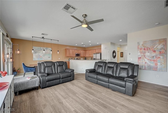 7460 Chaffinch St, North Las Vegas, NV 89084 - living area with light wood-type flooring, a ceiling fan, and recessed lighting