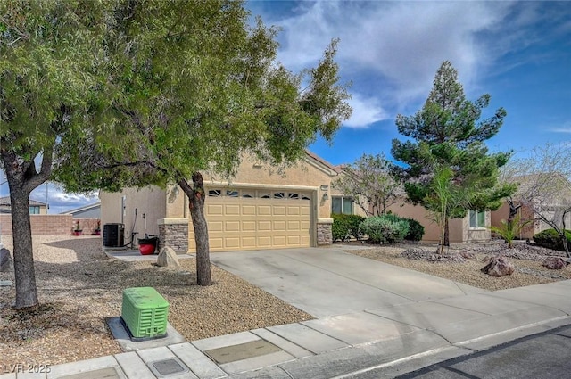7460 Chaffinch St, North Las Vegas, NV 89084 - view of property hidden behind natural elements featuring driveway, stucco siding, and stone siding