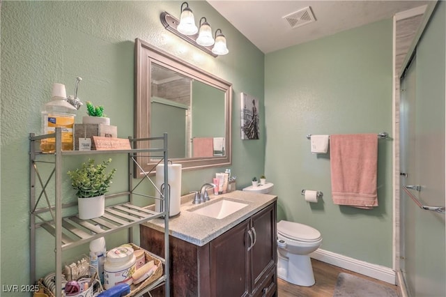 111 Narcissus Ln, Las Vegas, NV 89107 - full bath featuring vanity, wood finished floors, a shower with door, and a textured wall