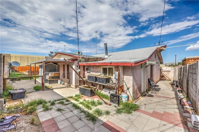 111 Narcissus Ln, Las Vegas, NV 89107 - rear view of house with a gate, a fenced backyard, stucco siding, and a patio