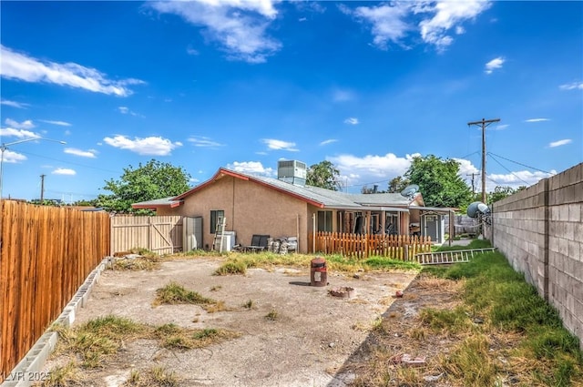 111 Narcissus Ln, Las Vegas, NV 89107 - back of house featuring a fenced backyard and stucco siding