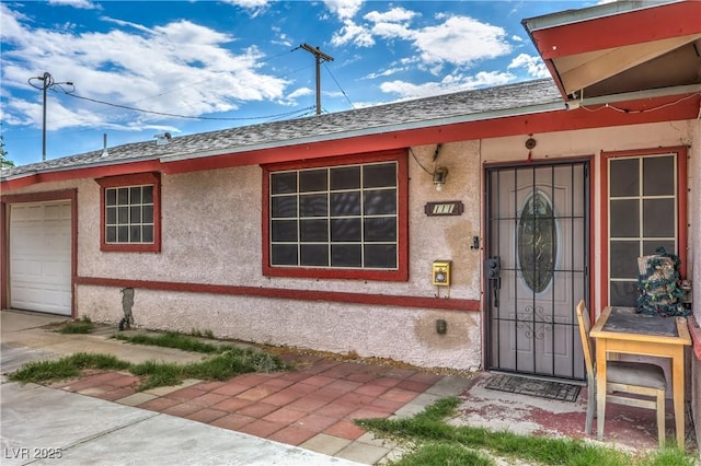 111 Narcissus Ln, Las Vegas, NV 89107 - property entrance with an attached garage and stucco siding
