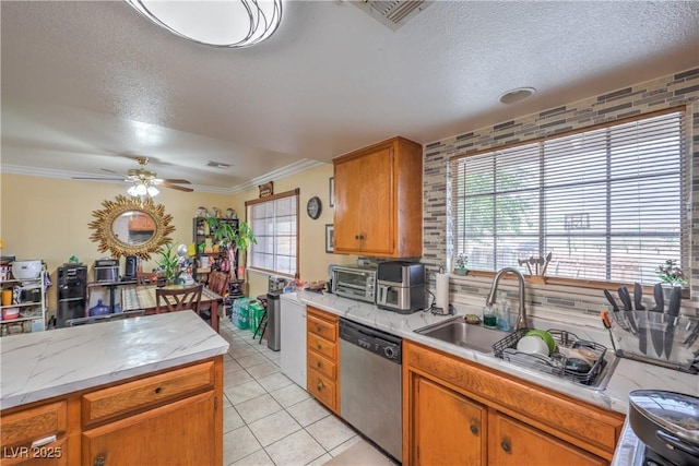 111 Narcissus Ln, Las Vegas, NV 89107 - kitchen with dishwasher, a textured ceiling, a ceiling fan, light tile patterned floors, and brown cabinetry