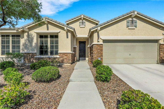 7125 Silver Ridge Peak St, Las Vegas, NV 89166 - view of front of house featuring stone siding, stucco siding, concrete driveway, and a garage