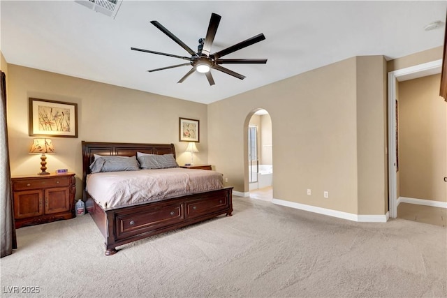 7125 Silver Ridge Peak St, Las Vegas, NV 89166 - bedroom featuring arched walkways, light colored carpet, ensuite bathroom, and a ceiling fan