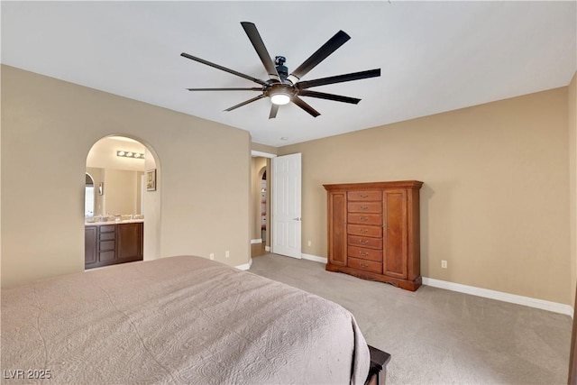 7125 Silver Ridge Peak St, Las Vegas, NV 89166 - bedroom with light colored carpet, arched walkways, ensuite bathroom, and a ceiling fan