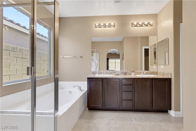 7125 Silver Ridge Peak St, Las Vegas, NV 89166 - bathroom featuring a bath, double vanity, plenty of natural light, and tile patterned flooring