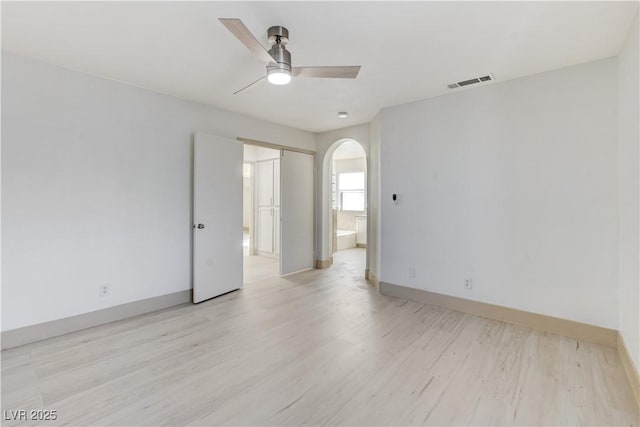 9409 Hershey Ln, Las Vegas, NV 89134 - unfurnished room featuring a ceiling fan, light wood-style flooring, and arched walkways