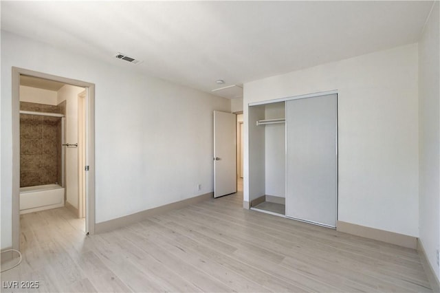 9409 Hershey Ln, Las Vegas, NV 89134 - unfurnished bedroom with light wood-type flooring, a closet, and connected bathroom