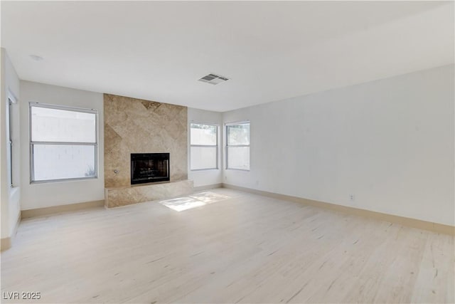 9409 Hershey Ln, Las Vegas, NV 89134 - unfurnished living room featuring light wood finished floors and a fireplace